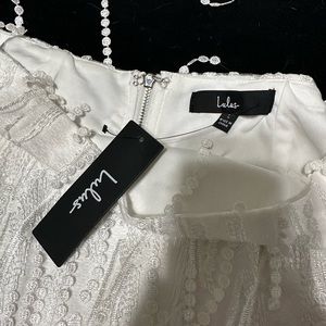 White halter top and matching skirt. White with fringe. Never worn!